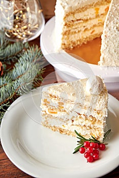 Slice of cake with coconut and peaches decorated for Christmas