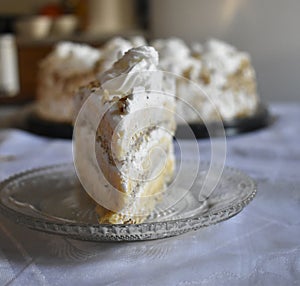 A slice of cake in front of the whole cake