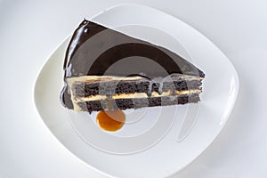 Slice of caramel chocolate cheese cake on white plate