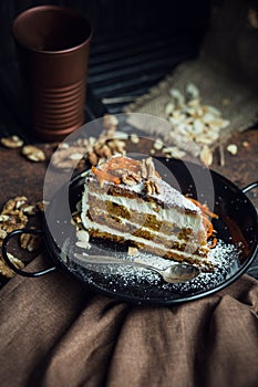 Slice of carrot cake with cream cheese and walnuts. The restaurant or cafe atmosphere. Vintage