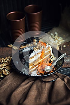Slice of carrot cake with cream cheese and walnuts. The restaurant or cafe atmosphere. Vintage
