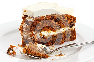 Slice of carrot cake with rich frosting.