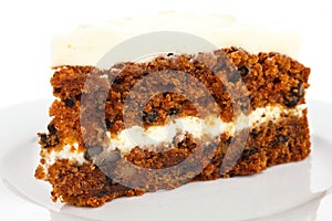 Slice of carrot cake with rich frosting.