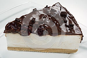 Slice of cheese cake with chocolate and cherries