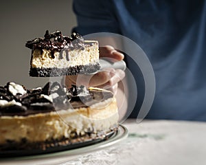 Slice of cheesecake with biscuits and dripping chocolate cream