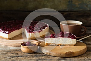 Slice of cheesecake with cup of tea on the table