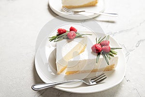 A slice of cheesecake with raspberries on a plate. Close-up