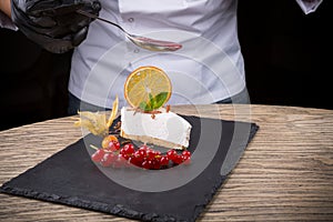 Slice of cheesecake served with red berries