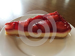 Slice of cheesecake with strawberries.