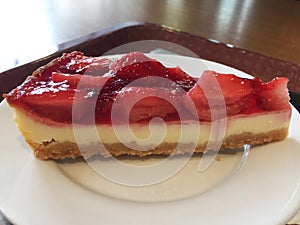 Slice of cheesecake with strawberries.