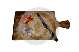Slice of chilis and red onion on wooden cutting board