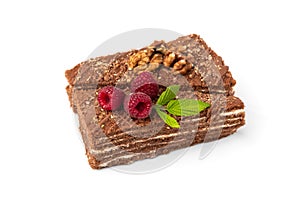 Slice of chocolate cake with raspberry and walnut isolated on white background