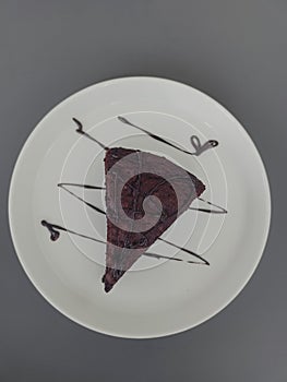 Slice of Chocolate Cake on White Plate