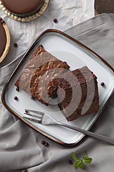 A slice of chocolate cake on a white plate.