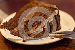 Slice of Chocolate Fudge Cake with fork on a plate A