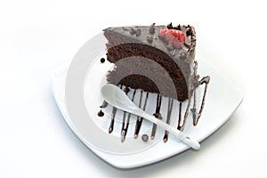 Slice of chocolate layer cake with strawberries