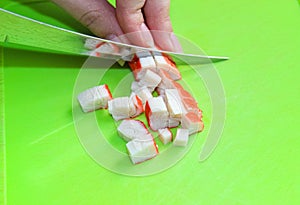 Slice the crab sticks on a cutting Board for the salad