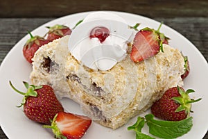 Slice of cream puff cake with strawberry on wooden table. Select