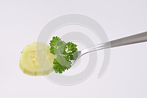 Slice of cucumber on fork