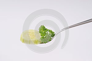 Slice of cucumber on fork
