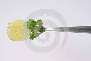 Slice of cucumber on fork