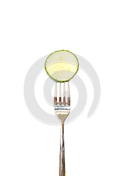 Slice of cucumber pinned on a fork