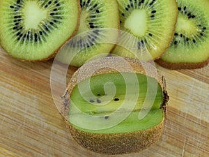 Slice cut kiwi brown green black background healty fruits