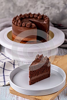 Slice of delicious homemade chocolate cake soft fudge.
