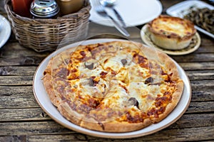 Slice of delicious pizza On a plate on wooden table