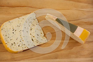 Slice of dutch gouda cheese on chopping board