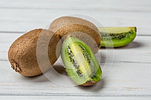 Slice of fresh kiwi fruit on white background