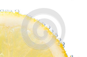 Slice of fresh lemon with fizz bubbles photo