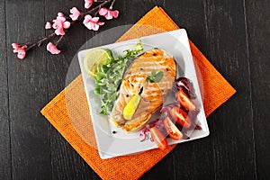 Slice of fresh salmon with tomatoes and salad