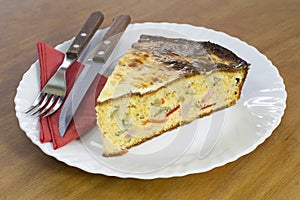 Slice of Freshly Baked Cornbread With Vegetables and Ham on White Plate