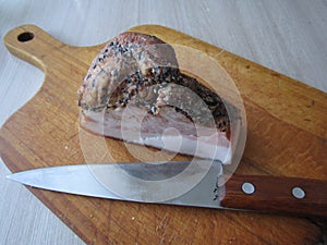 Slice of ham with spices on the board