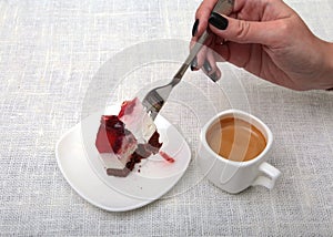 Slice of handmade cherry pie on a plate and classic espresso coffee in white background