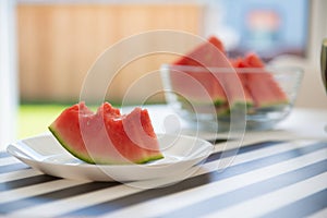 A slice of juicy red watermelon in white plate