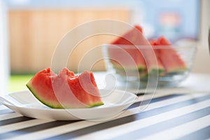 A slice of juicy red watermelon in white plate