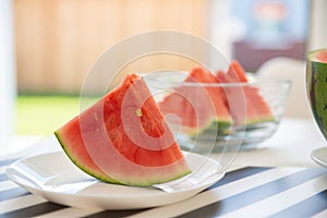 A slice of juicy red watermelon in white plate