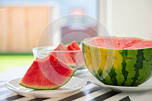 A slice of juicy red watermelon in white plate