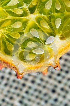 Slice of Kiwano, exotic vegetable cucumis metuliferus close-up. Soft focus. Vegetarian food