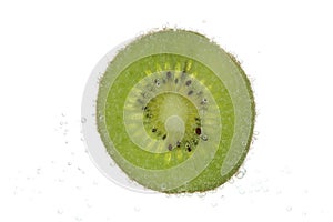 Slice of kiwi in carbonated water isolated