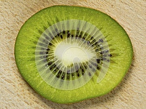 Slice of Kiwi fruit over wood background