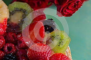 Slice kiwi and a variety of fresh fruits in sweet gelatin. Berries close-up in soft focus. Delicious dessert.