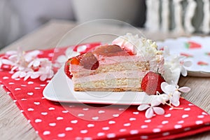 Slice of layered strawberry fruit cream cake