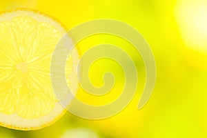 Slice of lemon on green and yellow background