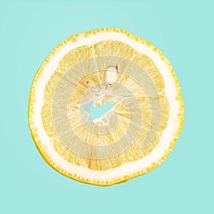 A slice of lemon isolated on blue background