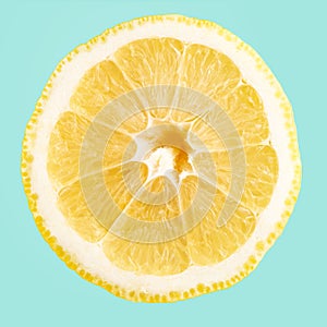 A slice of lemon isolated on blue background