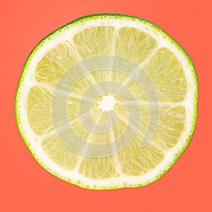 A slice of lime isolated on blue background