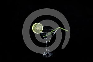 Slice of llime water and a glass with a cocktail